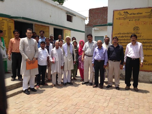 The members of AMU's core committee for adoption of villages at a nearby village.