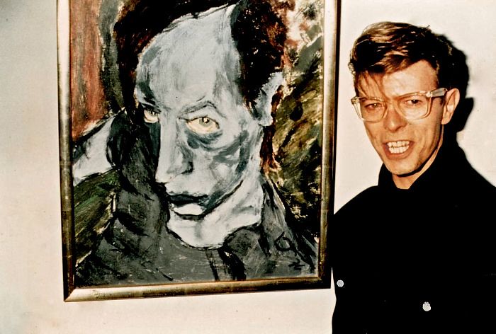 David Bowie standing infront of his painting Portrait Of JO, 1976 (this work was not on sale)