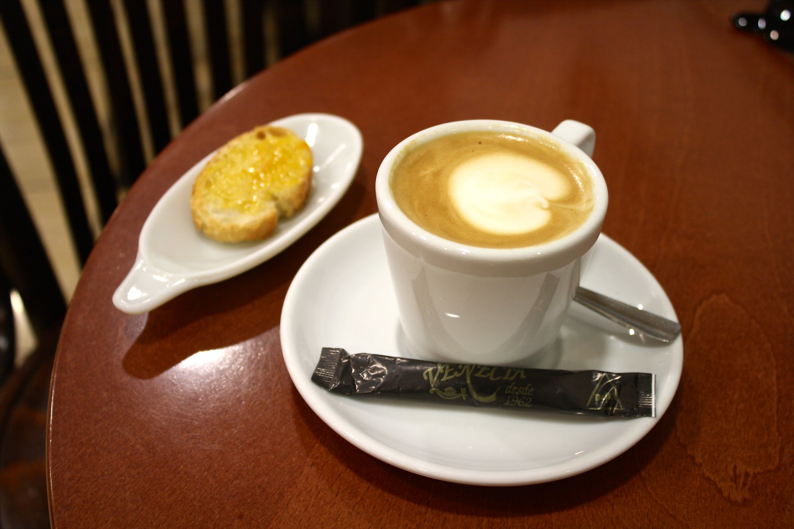 Latte with a slice of toast at Café Venecia, Santiago de Compostela, Spain