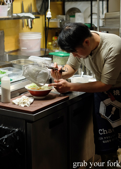 Chef Keita Abe transferring ramen noodles into bowls at Chaco Bar, Darlinghurst