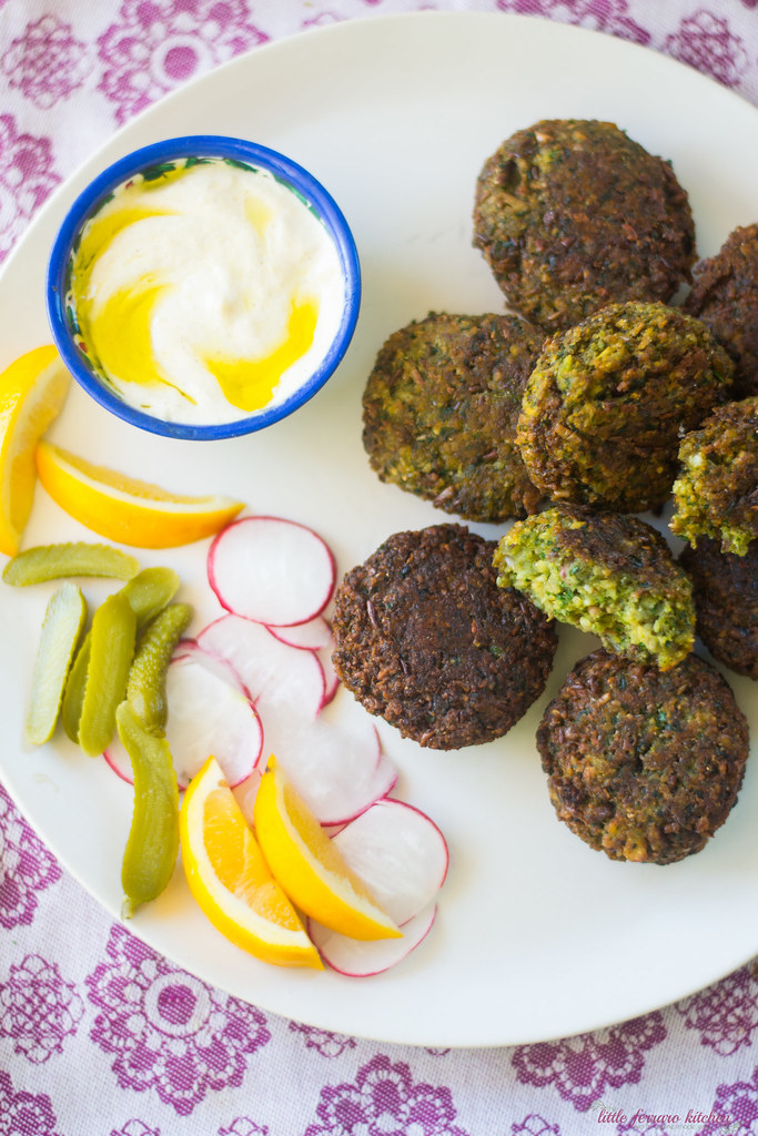 Homemade fava bean falafel filled with aromatics of parsley, cilantro and spices and perfectly fried. Serve with pickles, radishes and tahini sauce. 