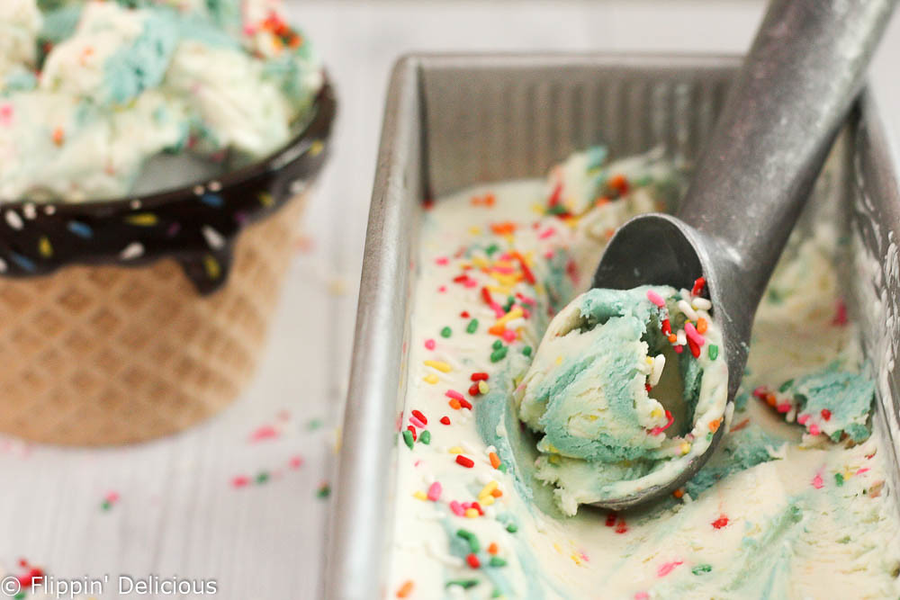 Creamy No-Churn Gluten-Free Birthday Cake Batter Funfetti Ice Cream, complete with a sweet buttercream frosting swirl and a healthy serving of sprinkles. Just like your favorite creamery cake batter ice cream, but better because it is gluten-free!