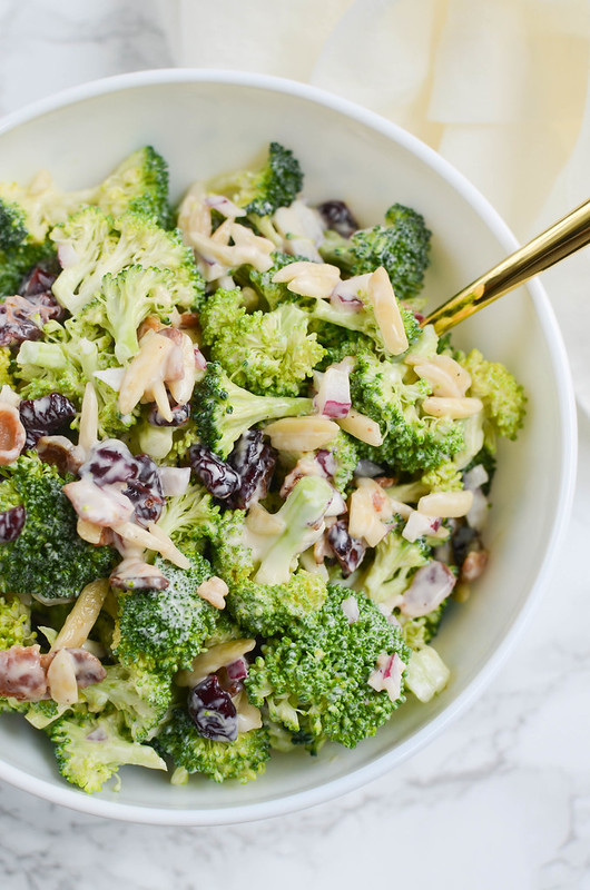 Cranberry Almond Broccoli Salad - a lightened up version of the classic! Broccoli, crumbled bacon, almonds, red onion, and dried cranberries in a creamy, tangy dressing. Perfect side dish for a summer party or a holiday dinner!