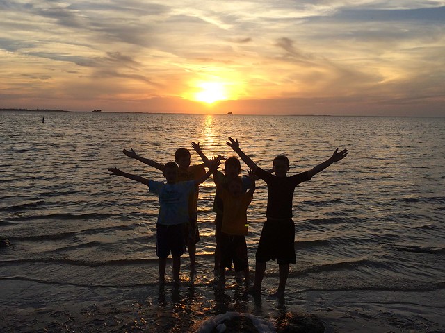 Kids in the lake at sun set