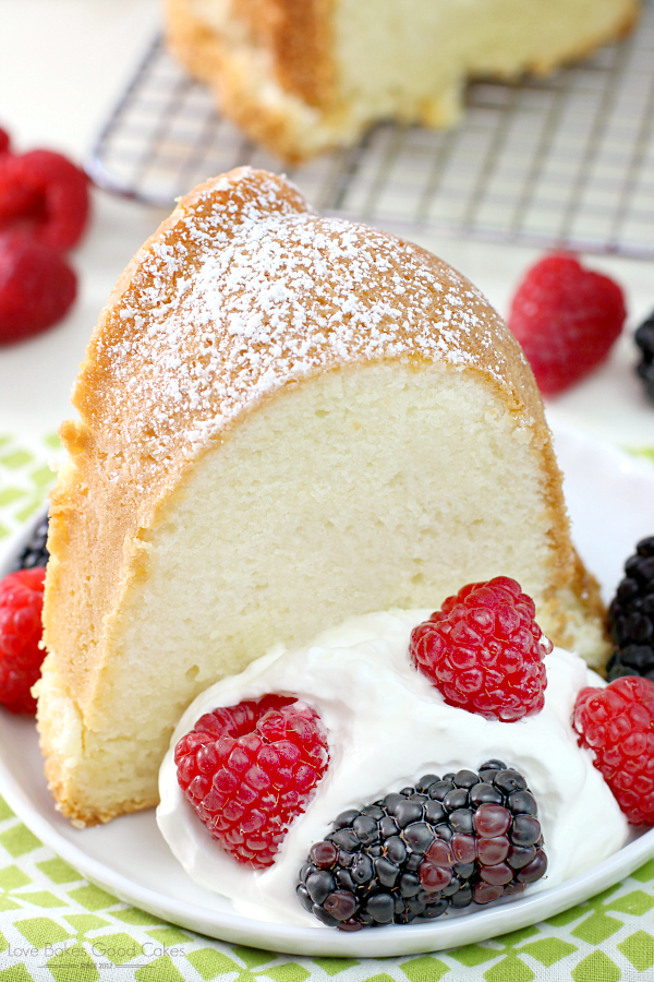 Old-Fashioned Cream Cheese Pound Cake close up on a plate with fresh berries.