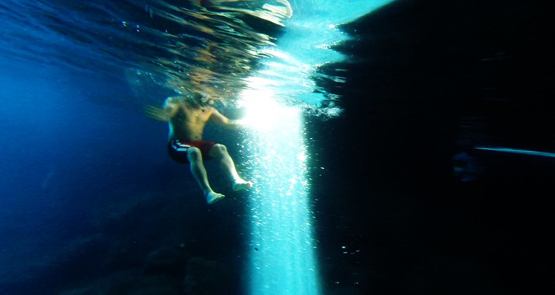 Green Cave, man diving next to blue light beam, island Vis, Croatia 1