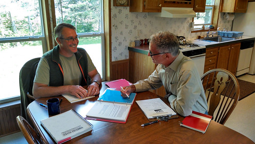A grower and an internal auditor look over records during a Good Agricultural Practices (GAP) audit. The grower is in the GroupGAP Program, which allows grower groups to pool their resources to establish food safety best practices, lead food safety trainings, develop quality management systems, and pay for certification costs. Photo courtesy of the Upper Peninsula Food Exchange.