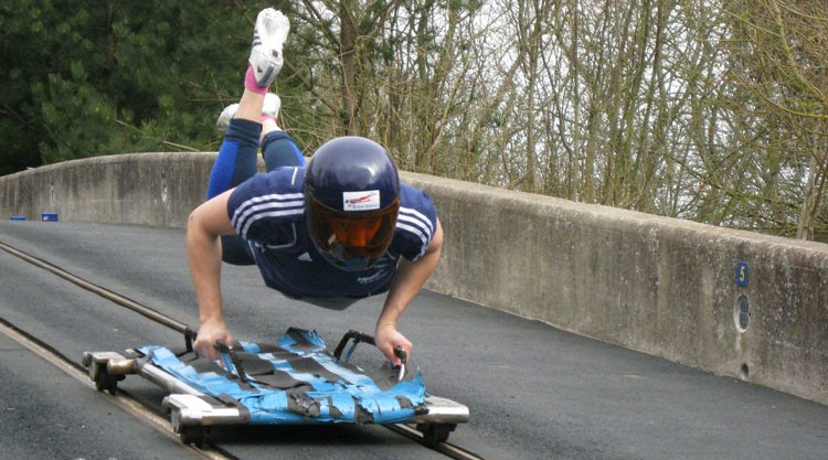An athlete practices on the campus skeleton track.