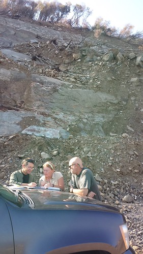 US Forest Service engineers discussing alternatives for reestablishing access on a road destroyed by the landslide