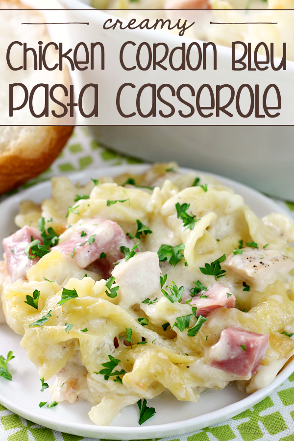 Creamy Chicken Cordon Bleu Pasta Casserole on a plate with a piece of bread nearby.