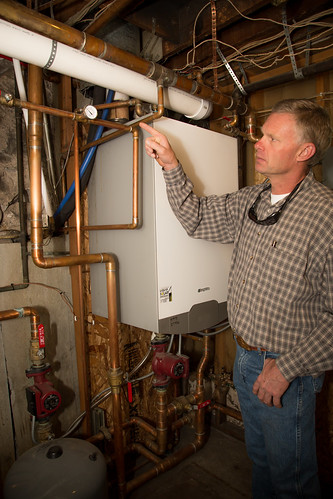 Mac Dean of the Yodeler Motel in Red Lodge, Mont. explains the thermal transfer system that supplies the motel's boiler with heated water, providing warmth to the Yodeler's rooms and common areas.