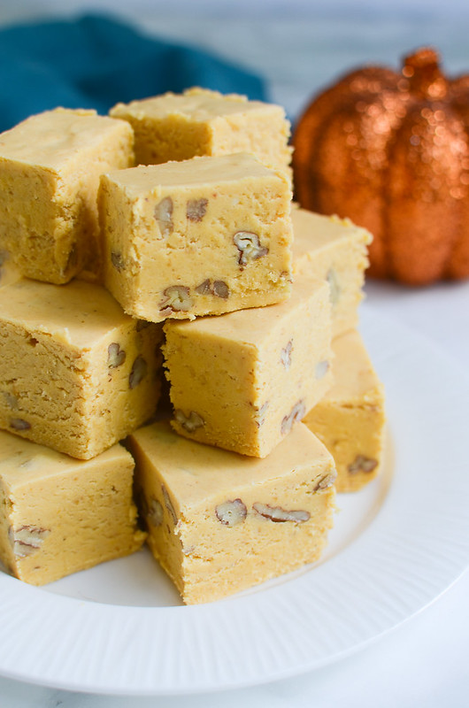 Pumpkin Pie Fudge - the taste of pumpkin pie in delicious fudgy bites! Pumpkin, white chocolate, marshmallows, and walnuts for a bit of crunch! Perfect for cookie tins at the holidays!