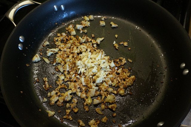 In a black nonstick pan, well-browned bits of cauliflower sizzle in butter, with a shower of chopped garlic just dropped in the middle of it all.
