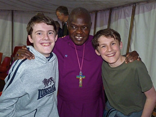 Archbishop of York (John Sentimu) with arms round shoulders of sons of tower captain
