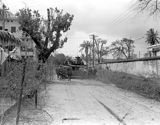 Street Shield - Marines use a M-48 tank as cover as they advance during street fighting in Hue, Feb. 3,1968