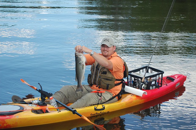 A kayak fisherman shows off his catch at Bear Creek Lake State Park, Virginia 