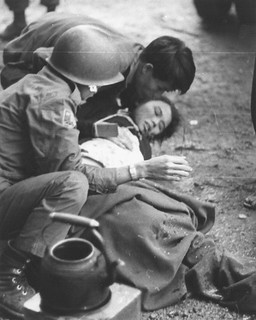 ARVN Forces and civilians aid a woman wounded in Hue during the communist Tet offensive in the imperial city