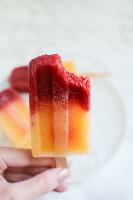 Raspberry-Peach Bellini Popsicles - boozy popsicles for summer! Mix frozen fruit with sparkling wine for this easy and delicious frozen treat!