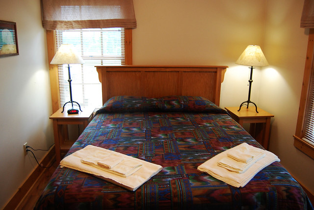 Cabin 1 master bedroom features a queen bed at Natural Tunnel State Park, Va
