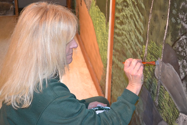 Staff member Kay Henderson painting mural at Grayson Highlands State Park, Virginia