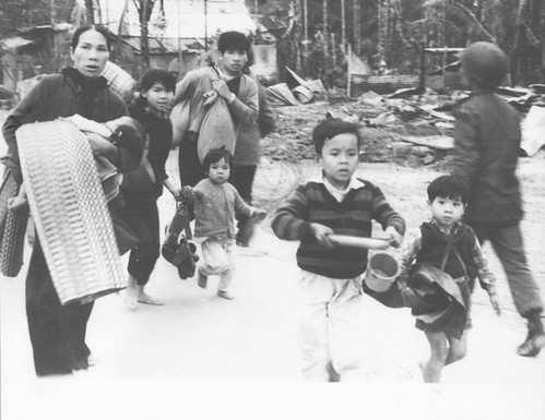 Civilians run to escape enemy fire during the 26-day battle for Hue Citadel