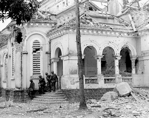 Marines leave church after successfully capturing it from North Vietnamese control