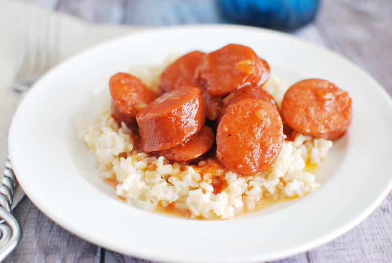 Slow Cooker Sweet and Sour Kielbasa - sliced kielbasa cooked in the crockpot in a delicious sweet and sour sauce. This is perfect over rice for an easy weeknight dinner or served by itself for a party snack!