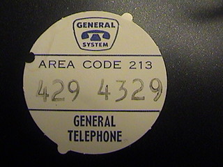 Automatic Electric model 80 number card  with locator tabs which key the location in the dial and a hole for the dial release tab tool