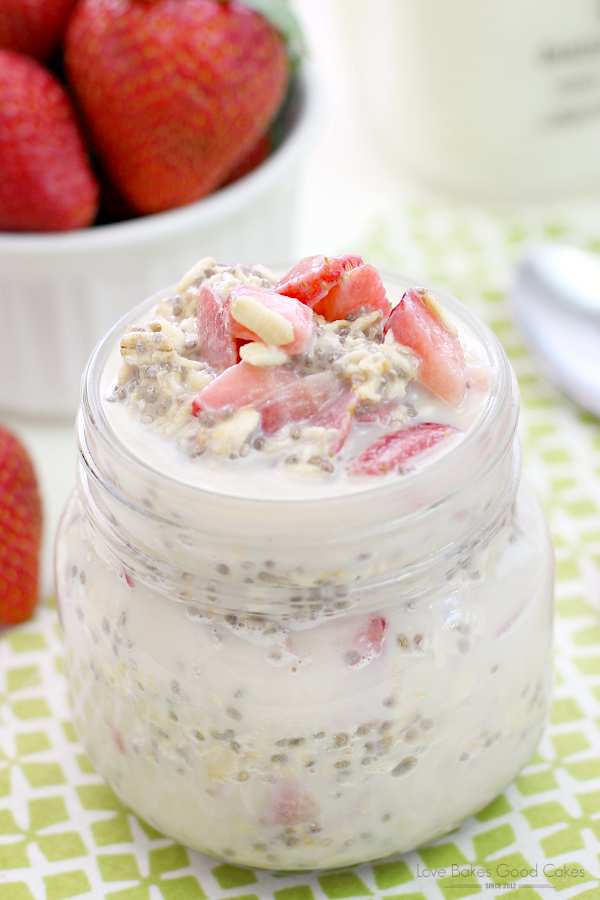 Strawberry Vanilla Overnight Oatmeal in a glass jar with fresh strawberries close up.