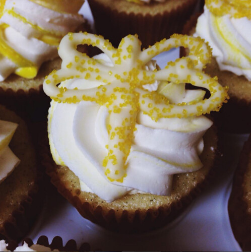 Image of a vanilla cupcake with a white chocolate dragonfly perched on top