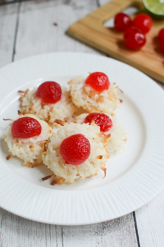 Ambrosia Macaroons - delicious coconut cookies filled with orange zest, lime juice, and dried pineapple. And topped with a cherry!