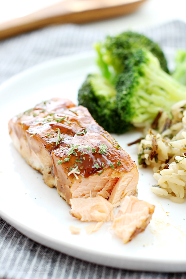 Dr Pepper Glazed Salmon with rice and broccoli on a white plate close up.