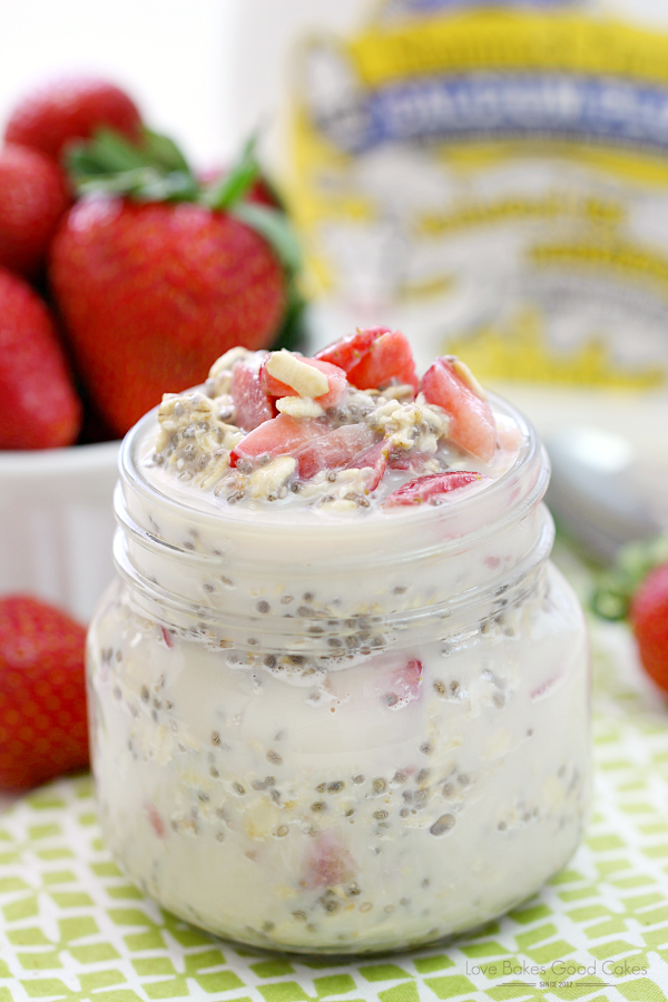 Strawberry Vanilla Overnight Oatmeal in a glass jar with fresh strawberries close up.