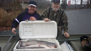 Photo of Two men with a cooler full of blue catfish