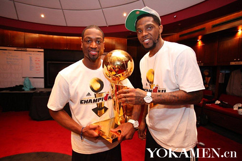 Miami Captain Udonis Haslem and Wade holding the team's second championship trophies
