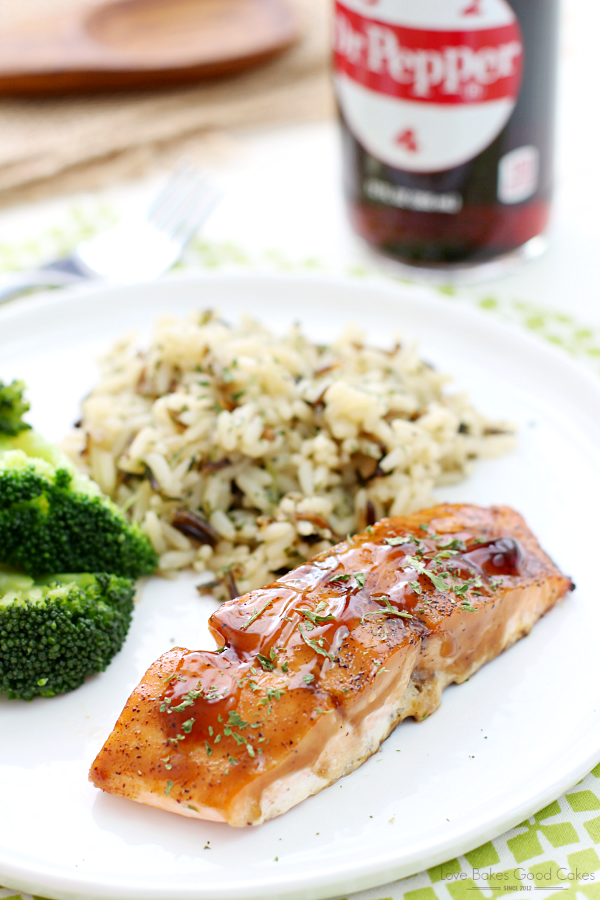 Dr Pepper Glazed Salmon with rice and broccoli on a white plate with a bottle of Dr Pepper.