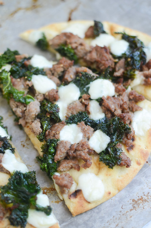 Sausage and Kale Naan Pizza - an easy and healthy way to do pizza night! Turkey sausage, kale, and mozzarella on top of delicious naan bread!