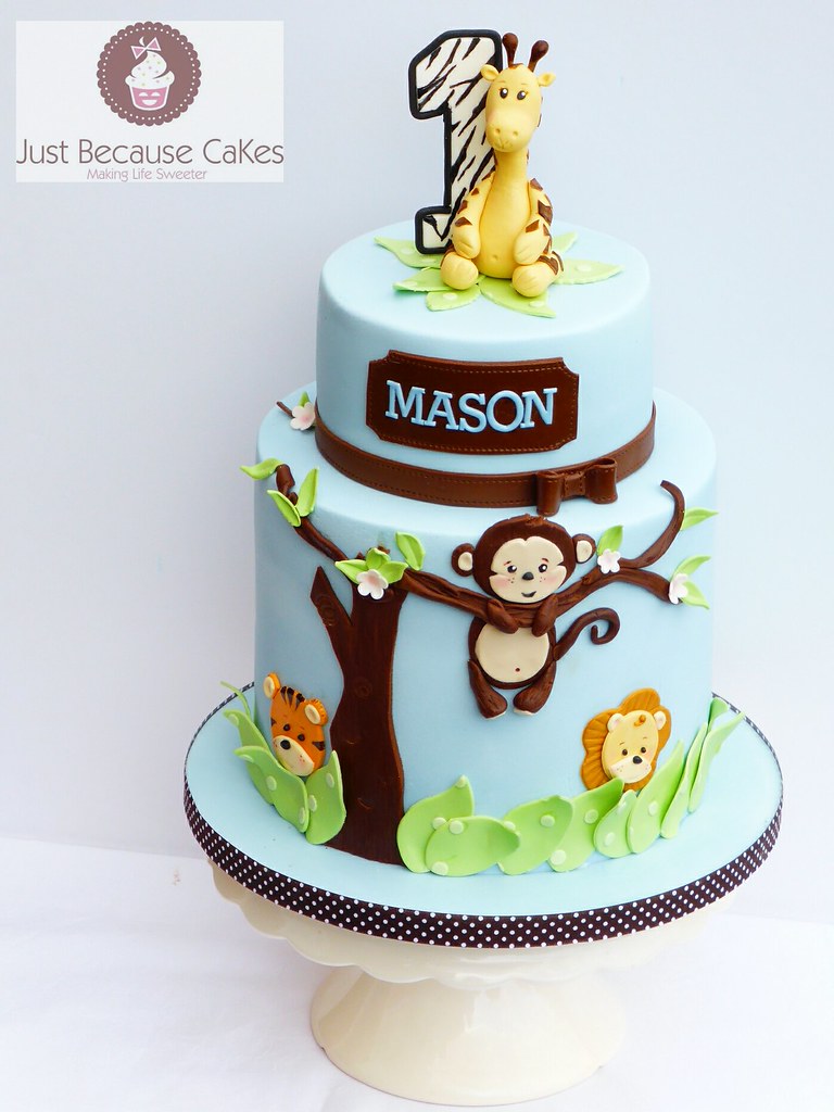 Jungle animals first birthday cake for a boy. A giraffe, a