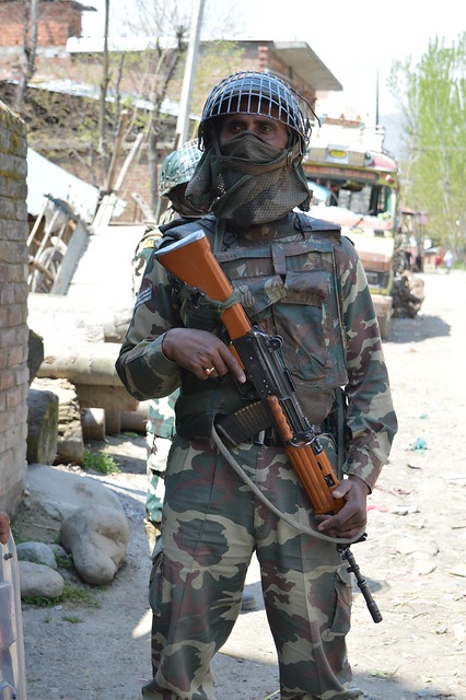 An alert CRPF personnel guarding the street in Tral