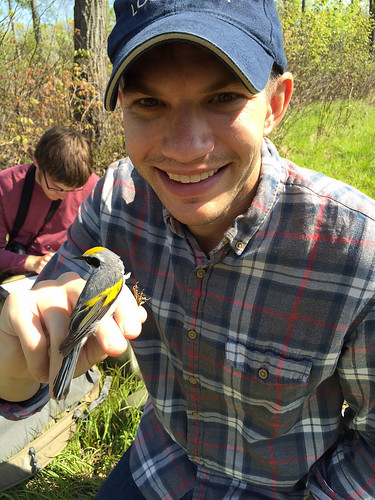 Justin Fritscher, NRCS public affairs specialist, with a newly banded golden-winged warbler