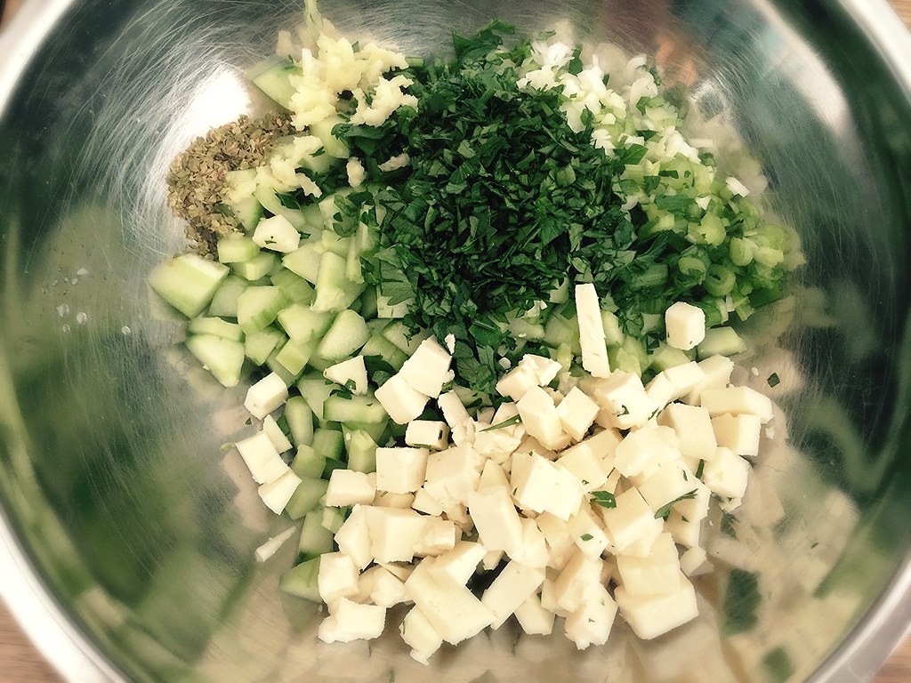 feta, cucumber, parsley and garlic in a mixing bowl