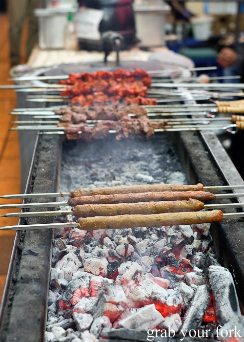 Seekh kebabs cooking over charcoal at the Ramadan food festival in Lakemba Sydney
