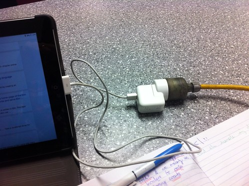 Charging up the IPad with a power cable, connector via USB.