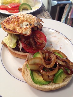 cheeseburger with bacon, sauteed onions, avocado, lettuce, tomato, and a fried egg