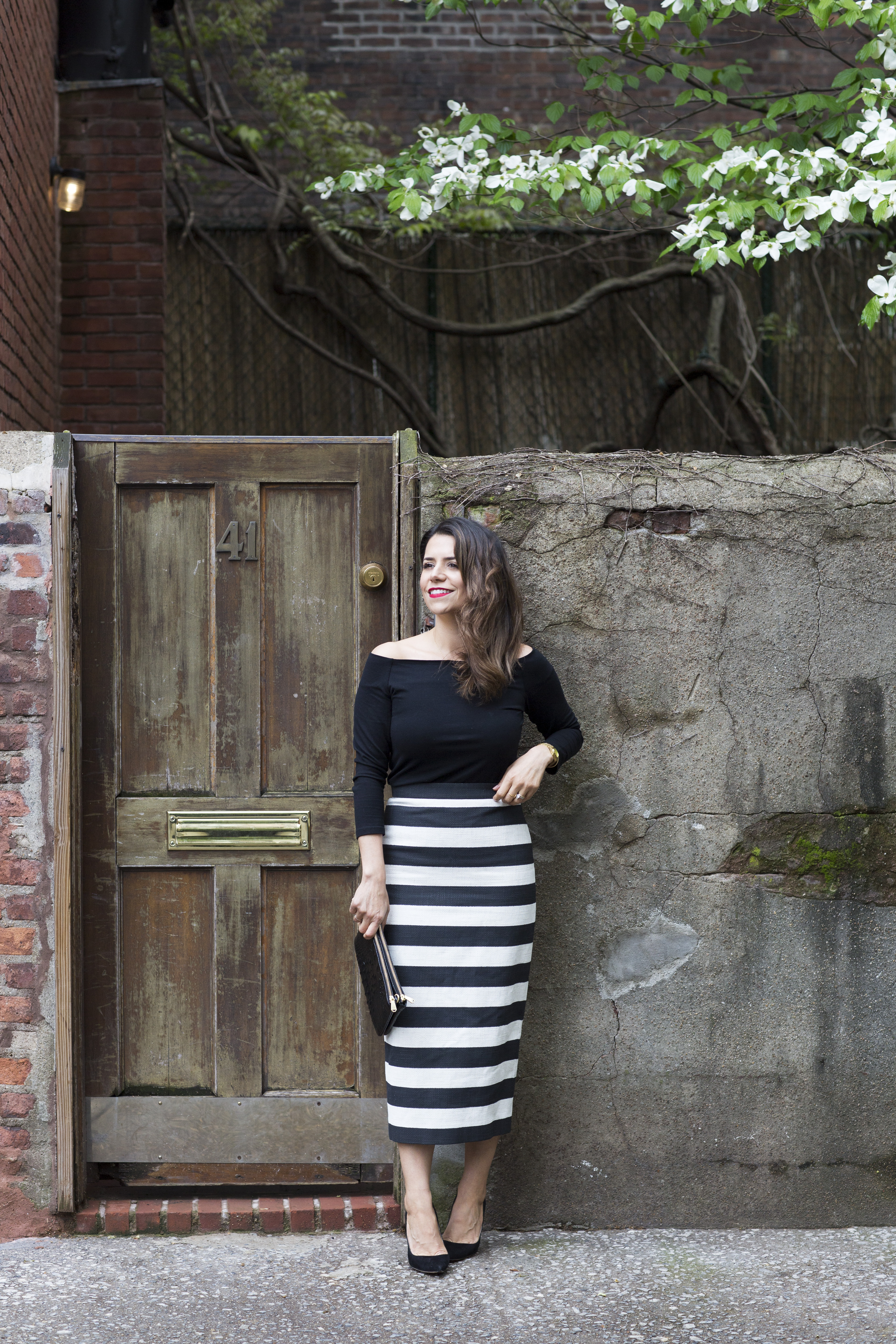 black and white stripe skirt with off the shoulder black top in spring on corporate catwalk