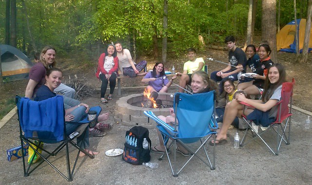 Exchange students enjoying marshmallows over a campfire at Bear Creek Lake State Park, Virginia