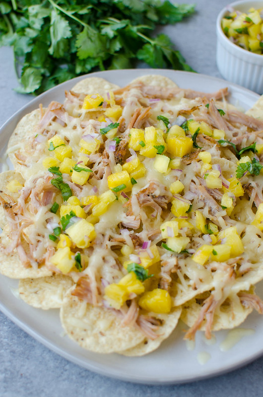 Pulled Pork Nachos with Pineapple Salsa - simple slow cooked pork piled on tortilla chips with monterey jack cheese and a quick and easy homemade pineapple salsa! 