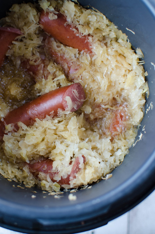 Crockpot Beer and Brown Sugar Kielbasa - kielbasa and sauerkraut cooked all day in the slow cooker in beer and brown sugar! It's sweet and sour and delicious! Perfect for Superbowl parties!